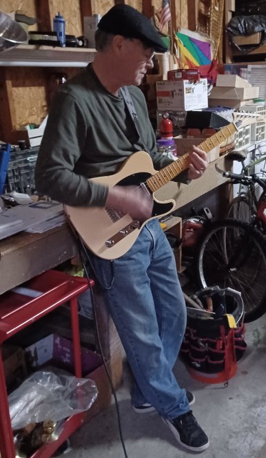Phil Kane playing guitar in the garage