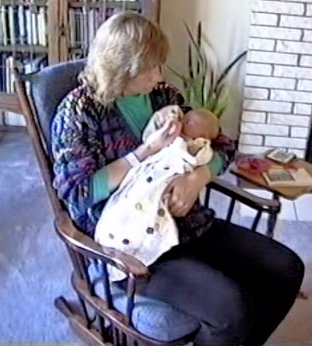 Donna with baby Hannah in rocking chair.